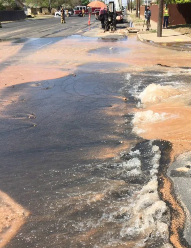 Forensic engineering expert witness inspecting damaged roadway conditions